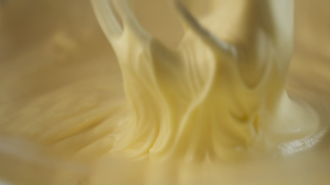 Whisk Mixing Egg Yolks, Sugar, And Mascarpone For Tiramisu. closeup shot