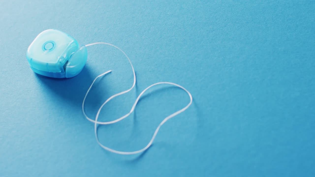 Video of close up of floss on blue background