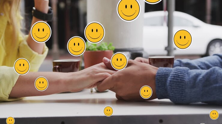 Animation of digital emoji icons floating over caucasian couple holding hands