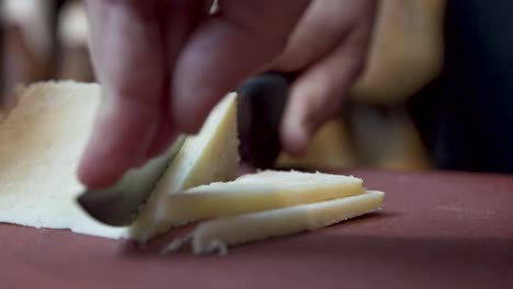 cutting a block of hard cheese