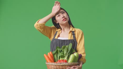 woman holding basket of vegetables