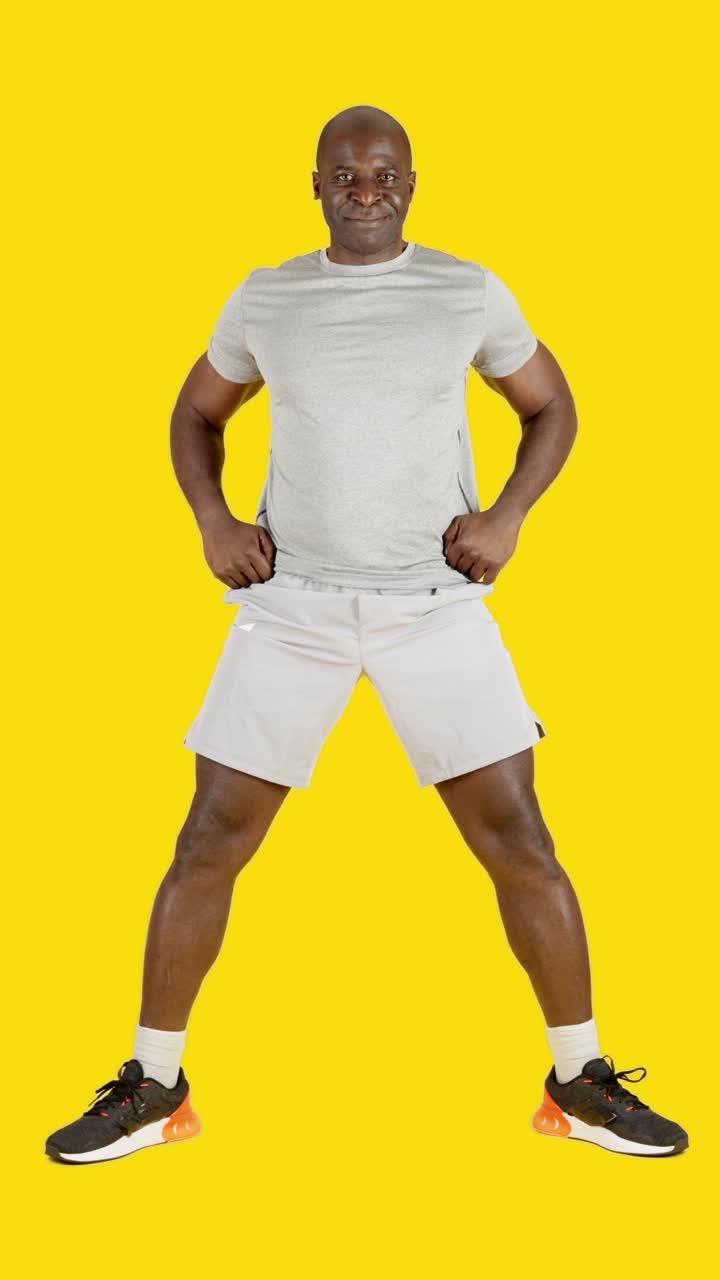 An strong african man doing sumo squats