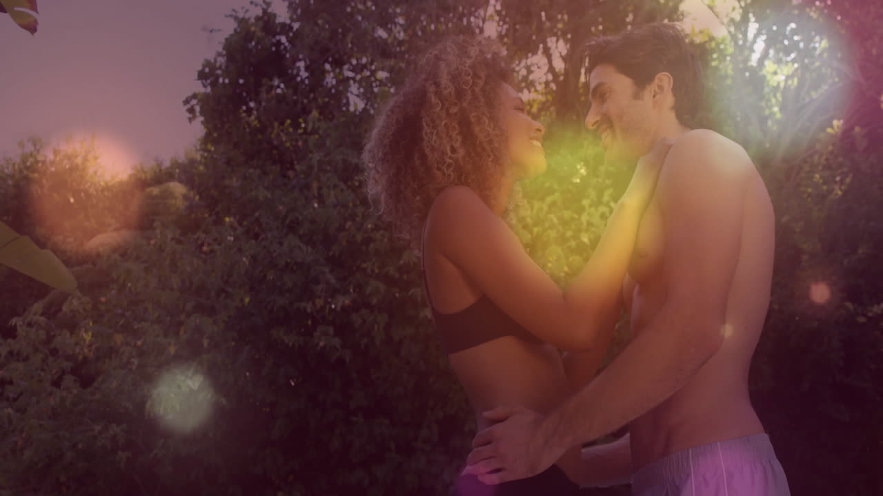 couple embracing in backyard garden at golden hour, highlighting fitness data chart overlay