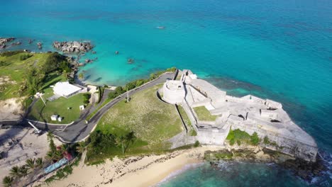 aerial view of old fort on tropical island overlooking turquoise ocean