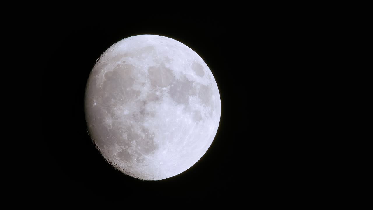 Incredible telephoto view of rare full blue supermoon moon rise, foreground dark shapes brush past
