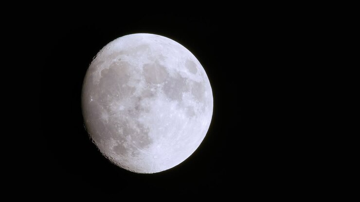 Incredible telephoto view of rare full blue supermoon moon rise, foreground dark shapes brush past