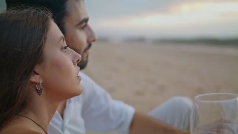 Sensual-woman-drinking-wine-glass-beach-closeup.-Young-newlyweds-celebrate-date