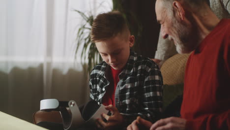 grandparents and grandchild using vr headset
