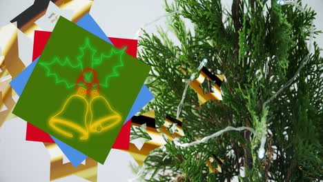 animation of neon christmas bells over christmas decoration and branches