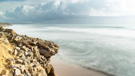 exotic ocean water rolling over sandy beach on sunny day, spain