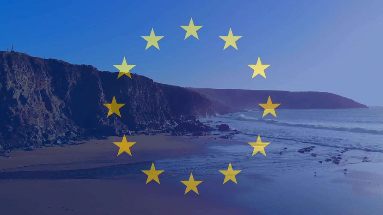 Estrelas aparecendo, formando um anel amarelo da UE sobre falésias e areia molhada para representar a UE, brilhando e depois desaparecendo.