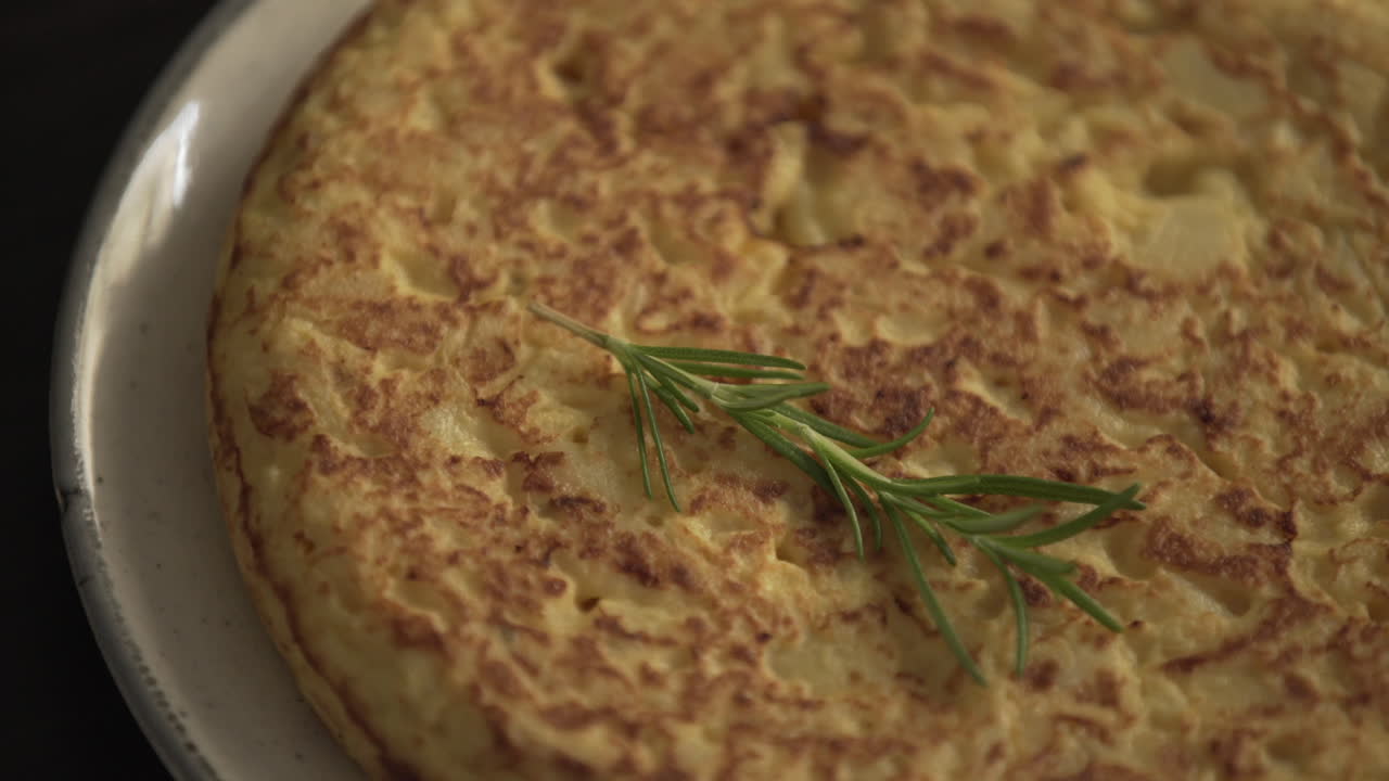 Rotating Spanish omelette, tortilla española. Close up