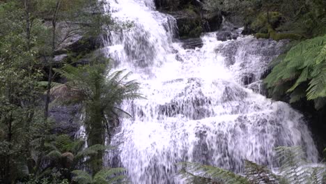 Large-waterfall-flowing-over-rocky-mountain-cliff