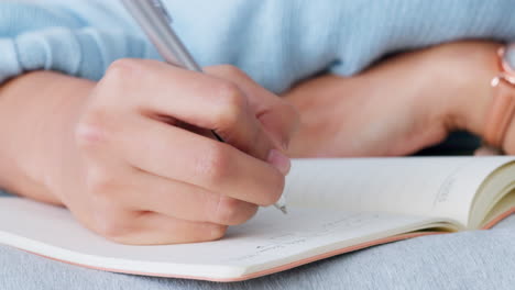 woman hands writing in notebook