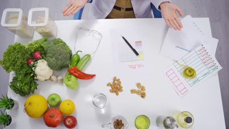 female nutritionist presents foods for healthy life.