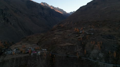 autumn colour aerial landscape of a beautiful and serene old mountain village on himalayan foothills