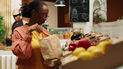 vegan woman taking locally grown vegetables from crates