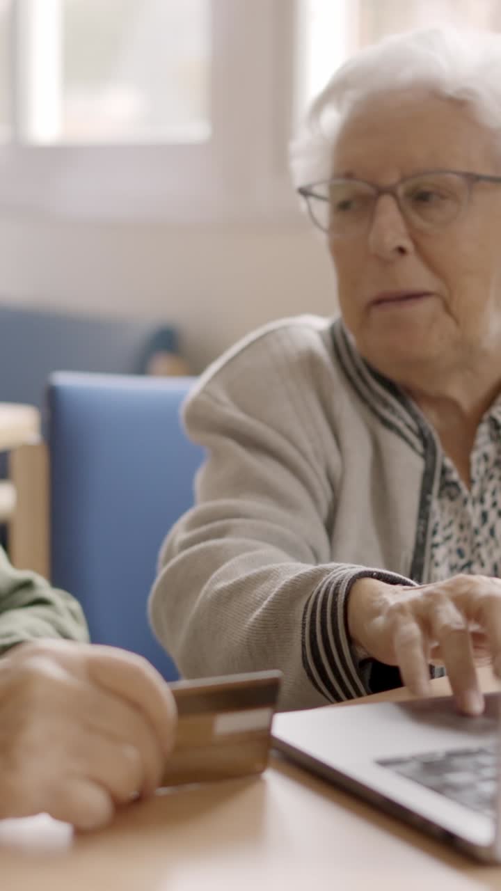 Senior people trying to shop online with laptop in geriatric