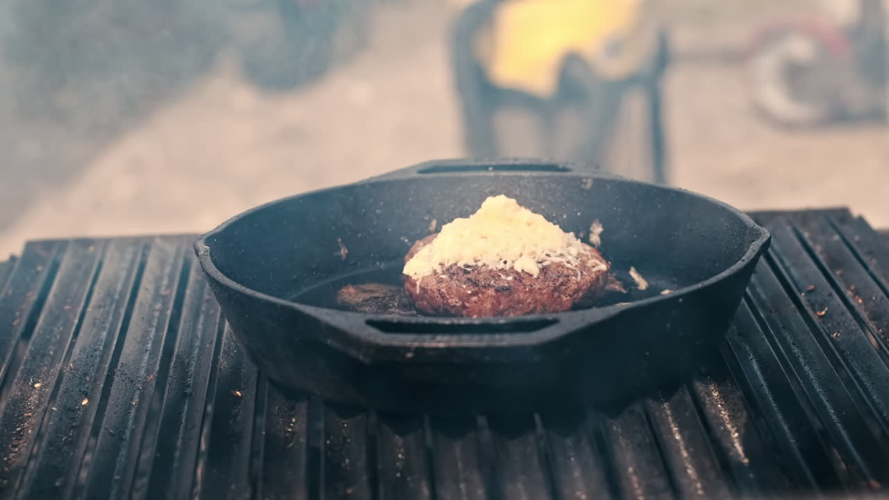Frying patty in a frying pan and man taking it. BBQ