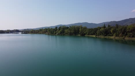 panoramic view over a beautiful landscape with a big natural lake surrounded by trees in the spanish mountains