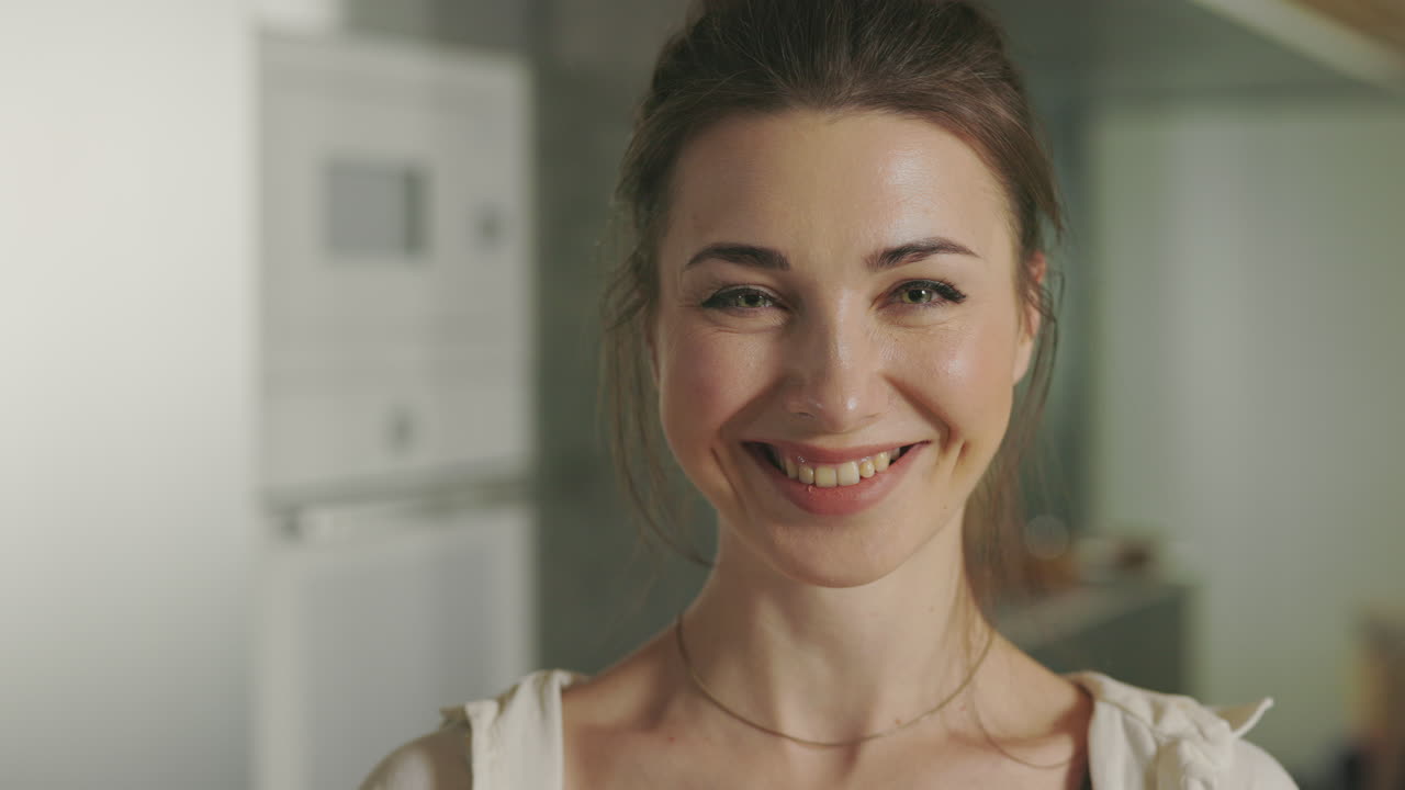 Happy Woman Playing with Tomatoes in Kitchen and Smiling