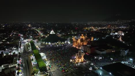 drone flying away from the basilica guadalupe and the barroque of santa maria, night in mexico