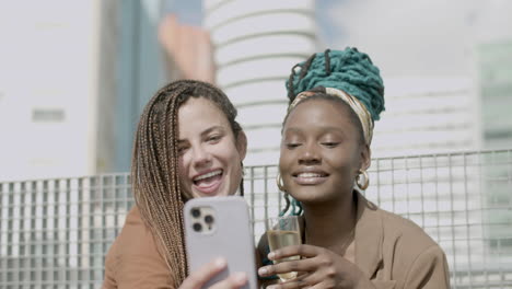 front view of diverse business women taking selfie at party