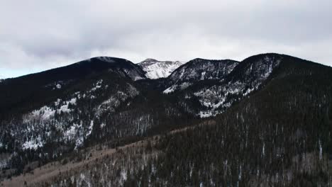 Drohnenschuss,-Der-Sich-Von-Einem-Hochgelegenen,-Schneebedeckten-Berg-Zurückzieht