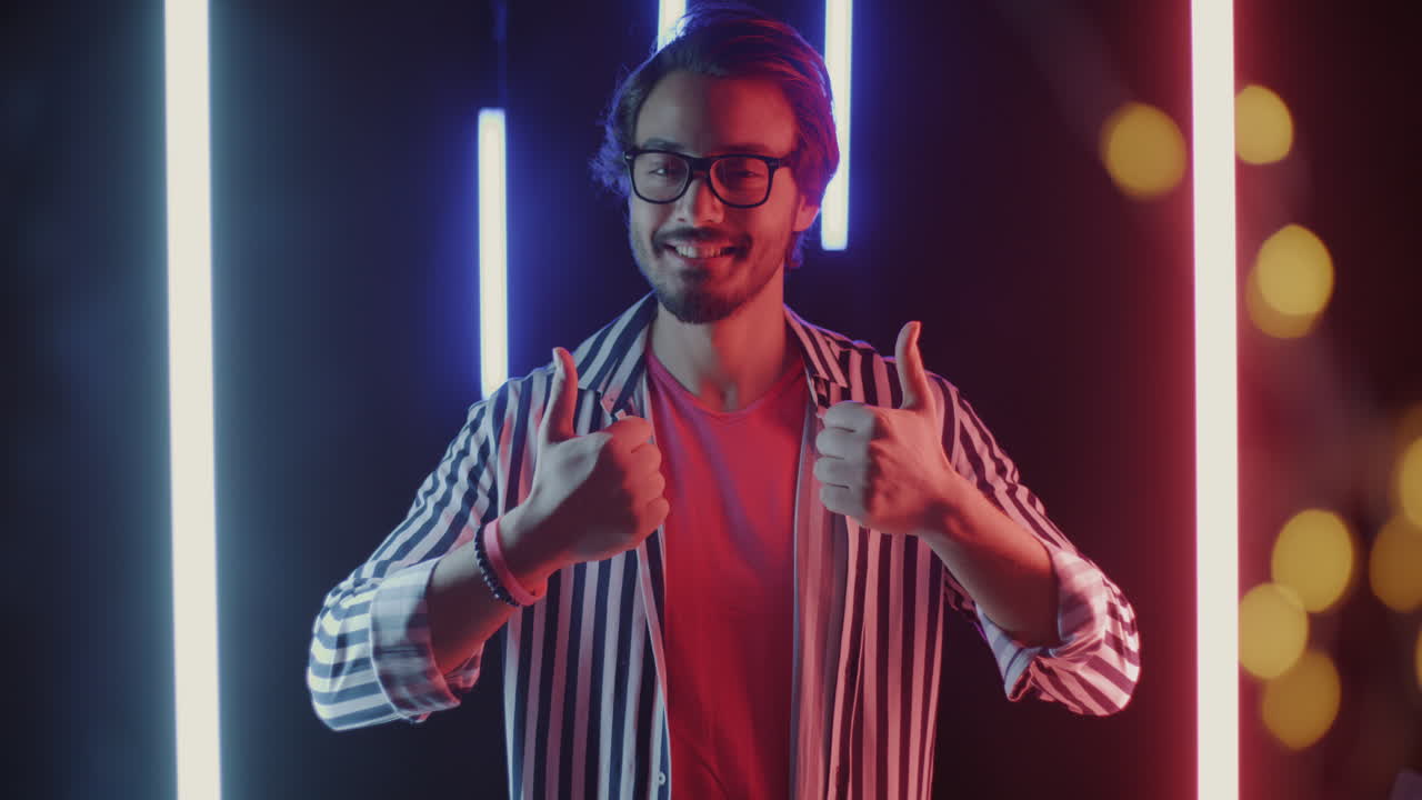 Man with thumbs up in neon light