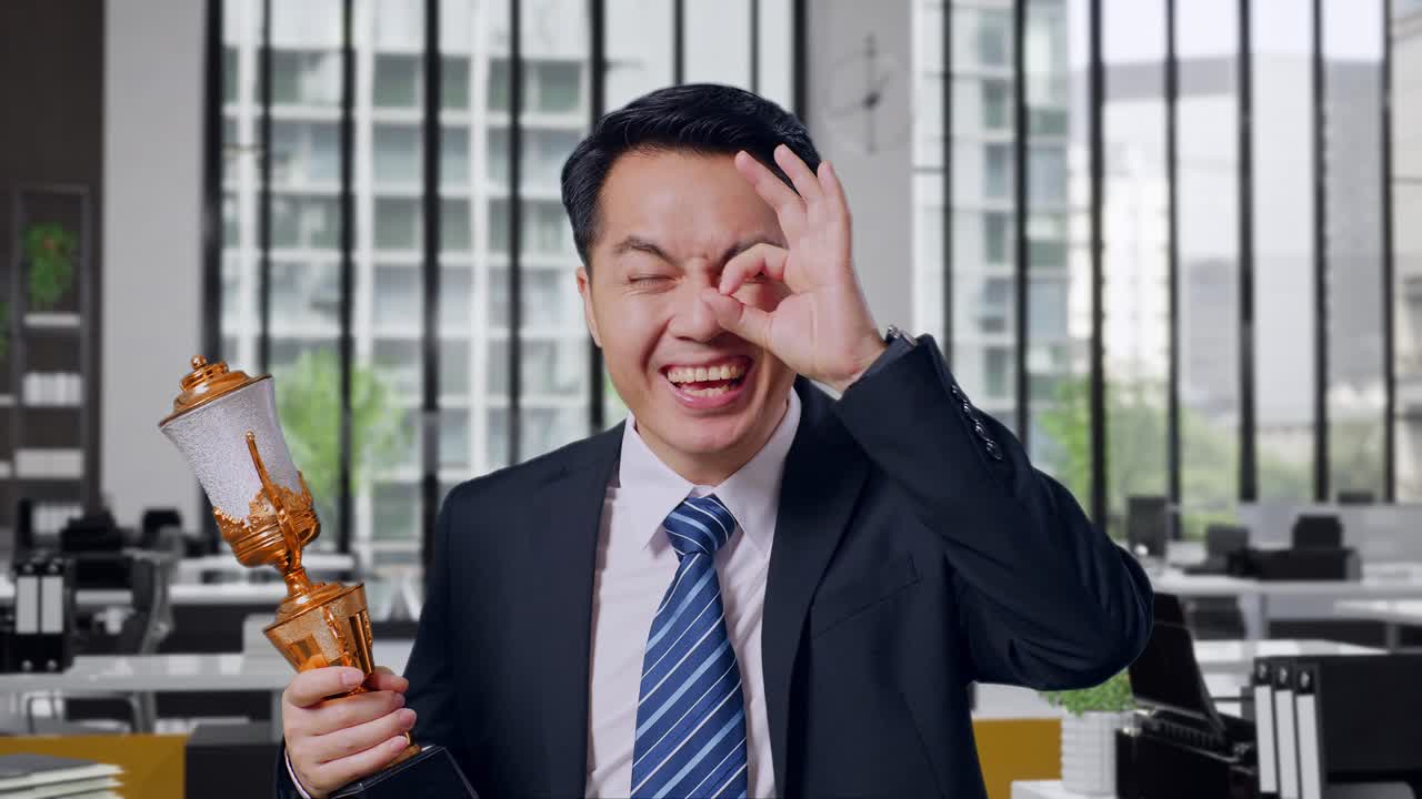 Businessman Celebrating Success with Trophy