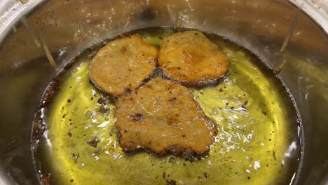 frying of malpua on hot oil. indian sweets.