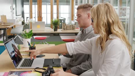 young man and woman working in a creative office