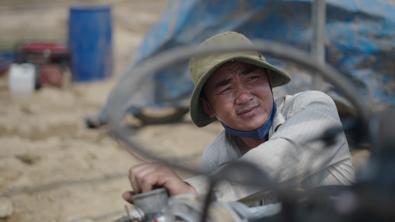 Farmer working on agricultural machinery