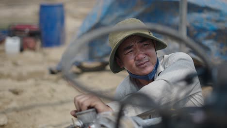 farmer working on agricultural machinery