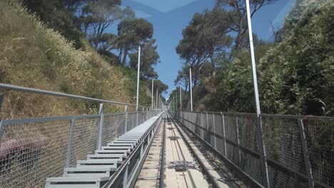 funicular railway climbing tibidabo mountain in fast motion, revealing the amusement park at its peak, offering scenic views of the surrounding landscape and cityscape of barcelona