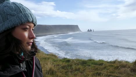 medium shot of woman with ocean cliff backdrop