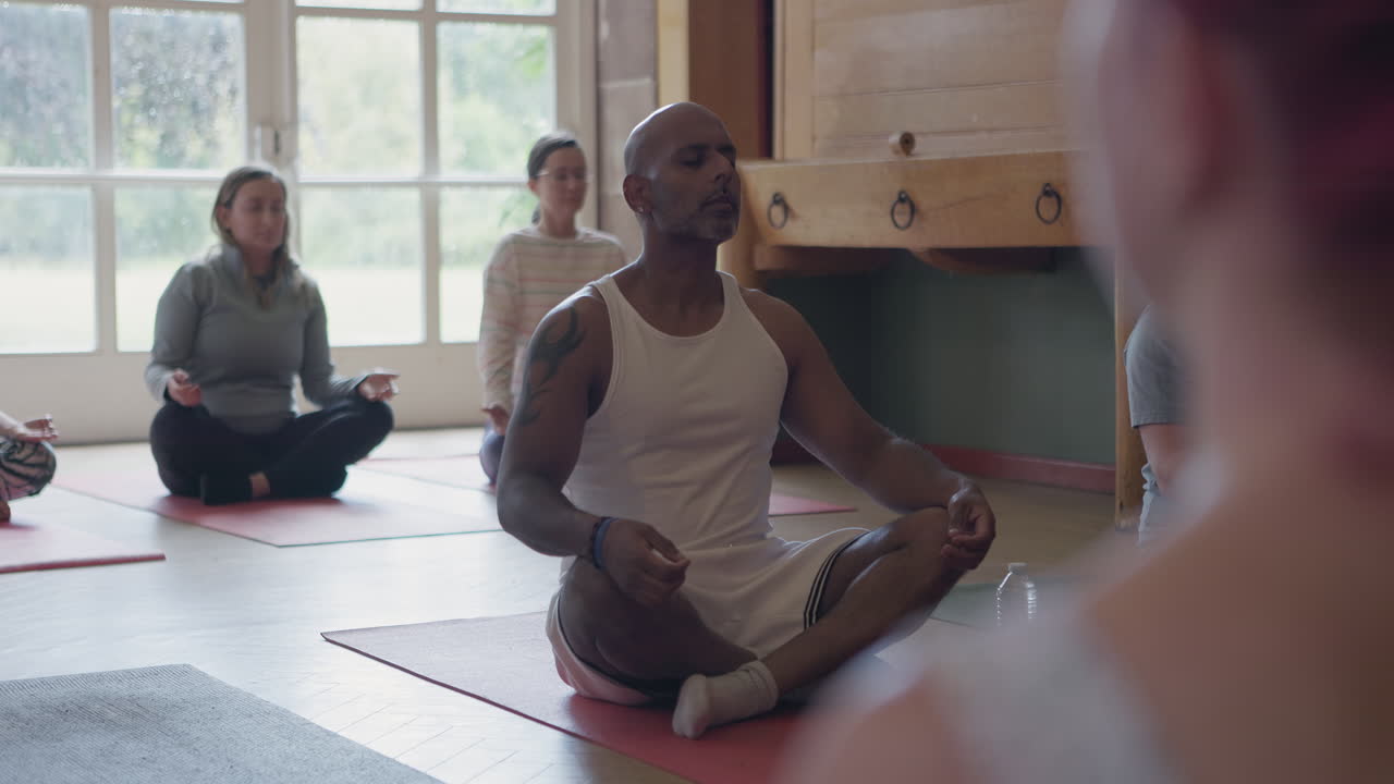 Yoga group meditating indoors