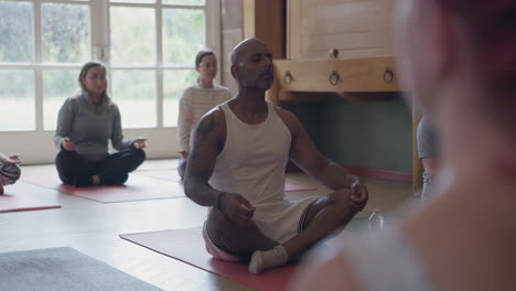 yoga group meditating indoors