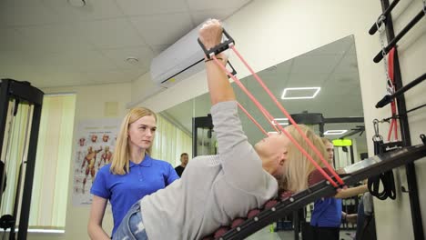 physical therapy session with resistance bands and trainer