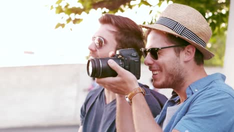 hipster friends taking pictures with an old camera