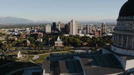 drone shot showing the salt lake city, utah capitol building overlooking the downtown skyscrapers