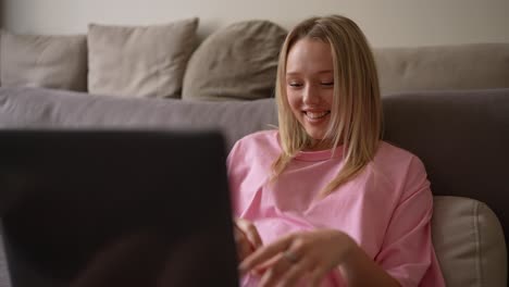 young woman using laptop on sofa