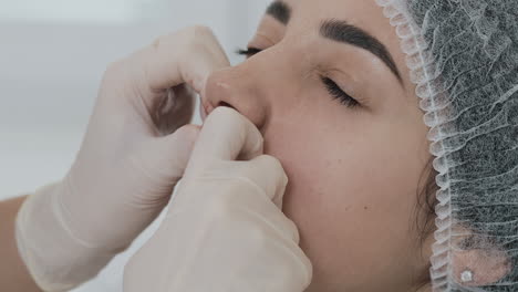 close-up of nose and lip body piercing or cosmetic procedure