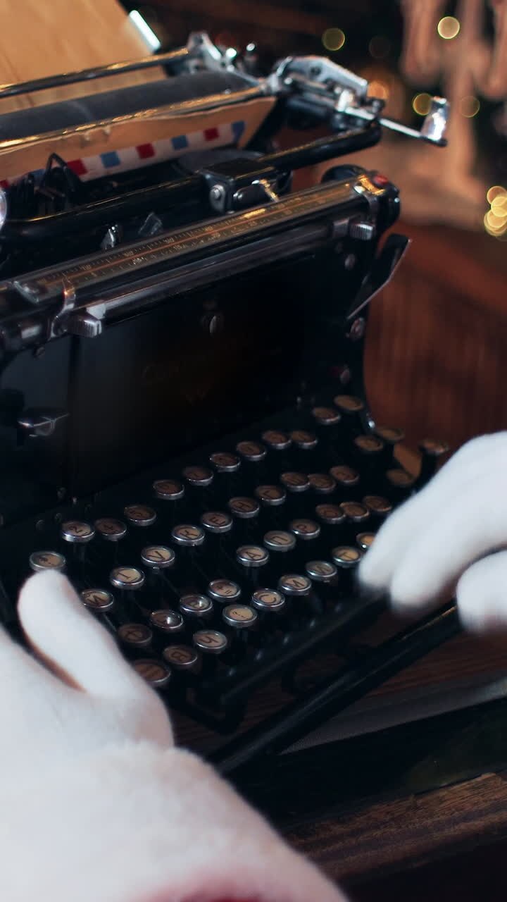Santa Claus writing reply to a letter on a typewriter. Close up. Vertical video