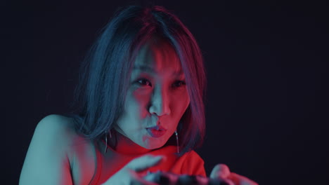 woman playing video games with neon lighting