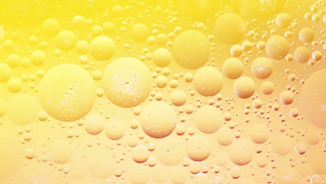 peaceful shot of bubbles illuminated with yellow light move around, slow motion