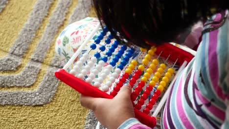 child playing with abacus