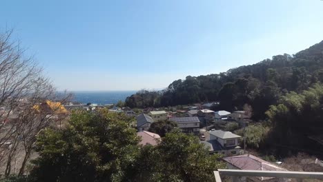 beautiful small fishing town in japan passing by in front of train window