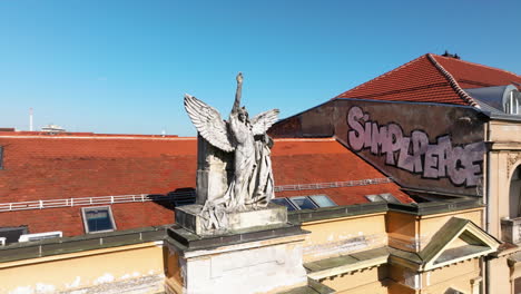 angel sculpture on top of building facade in zagreb, croatia