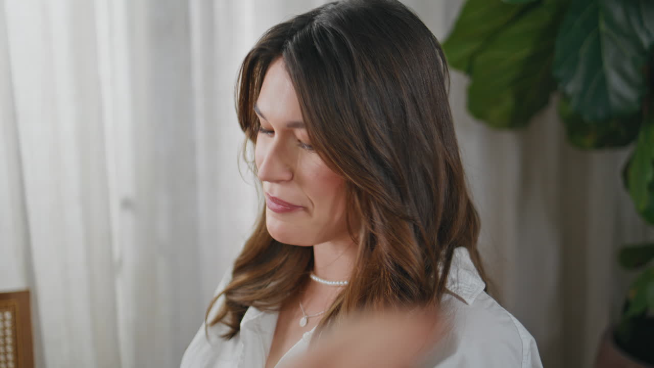 Smiling brunette talking friends at modern home interior closeup. Cheerful woman